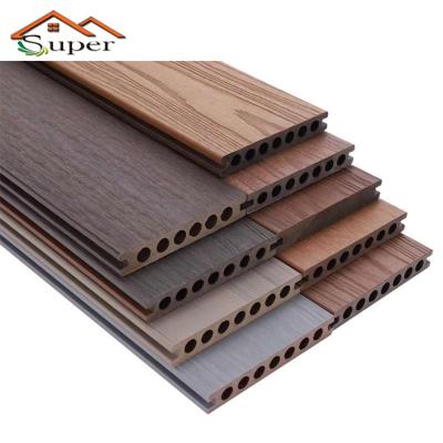 China Waterproof Round Hollow Coextrusion Wpc Interlocking Pavers Veneer Laminated Decking Tiles Prices for sale