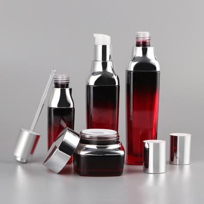 China 35Ml 50Ml 100Ml 120Ml Silver Cap Pump Dark Red Gradient Glass Skin Care Set Cosmetic Jars And Bottles Luxury Skincare Packaging for sale