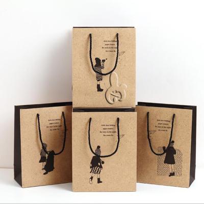 China Gift & 2022 Cute Eco-friendly Craft Clothing Kraft Paper Brown Shopping Takeout Bag With Handle Wholesale Paper Bag for sale