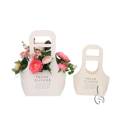 China Recyclable wholesale creative bouquet packaging stock paper bag waterproof gift bag handheld packaging custom logo catering bag for sale