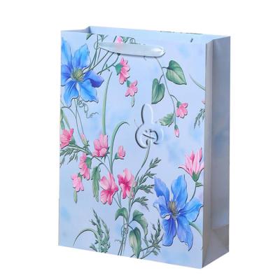 China 2022 wholesales price flower pattern gift recyclable cheap luxury custom printed paper shopping bag with your own logo for sale