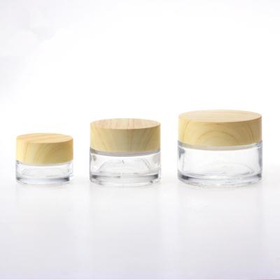 China 5g 10g 15g 30g 50g 100g Cosmetic Clear Glass Cosmetic Cream Jar With Wood Grain Cap For Eye/Face Cream for sale