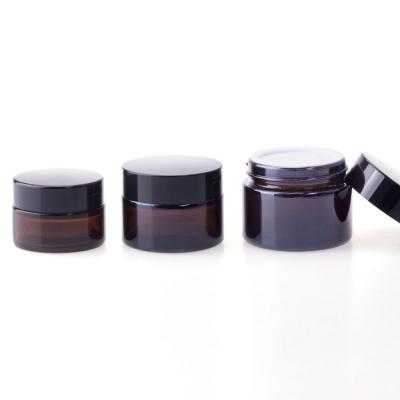 China 5g 10g 15g 30g 50g 100g Cosmetic Amber Glass Eye/Face Cream Jar With Black Cap for sale