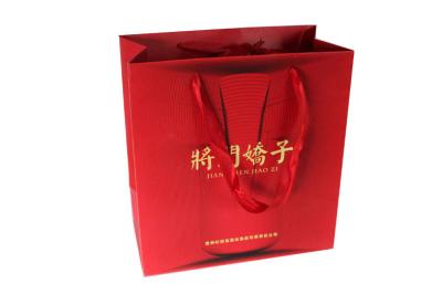 China Red Paper Shopping Bags , Matte Laminated Paper Bags With Knotted Handle for sale