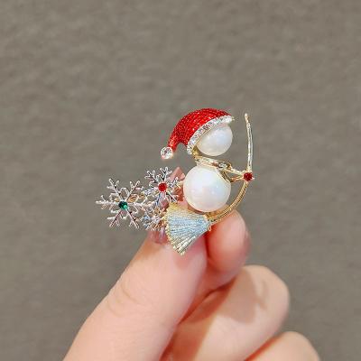 China Durable Snowman Wearing Christmas Hat Riding Bead Pin Alloy Material Cartoon Brooch Broom Pin for sale