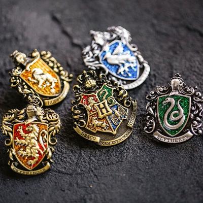 China Promotional Brooch Hary Europe 4 Universities Hogwarts 3D School Badge Antique Color Plated Enamel Glitter Pin With Retail Package for sale