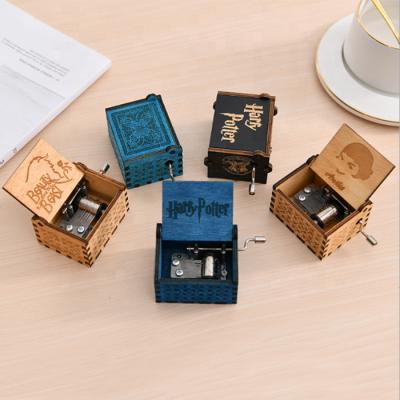 China OEM Hot Anime Mini Engraved Hand Cranked Wooden Creative Cut Out Music Box for sale