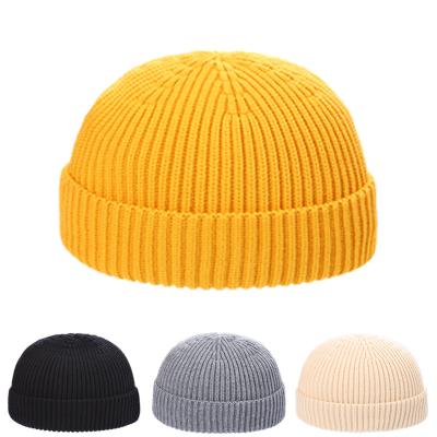 China Solid Color Hand Knitted Brand Beanie Winter Common Hat With Custom Label for sale