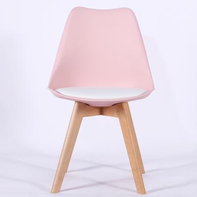 China Modern hot sale economical dining wooden legs pp restaurant furniture pink plastic dining chairs with PU cushion for sale