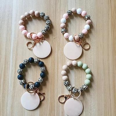 China New Flat Cut Silicone Wood Bead Key Chain Bracelet White Leopard Keychain Wrist Bracelet Fashion Wooden Silicone Wooden Bead Key Chain Custom Made for sale