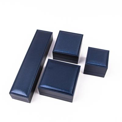 China Cheap and fine luxury elegant flip leather box luxury elegant dark blue jewelry packaging gift case for jewelry for sale