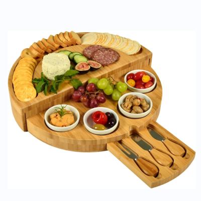 China Large Stocked Bamboo Cheese Cutting Dishes Panel Set and Knife Set with Hidden Slide Out Drawers Charcuterie Tray Panel for sale