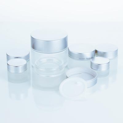 China Personal care 50ml 100ml transparent frosted glass cosmetic bottle eye cream bottle and silver plastic cover. for sale