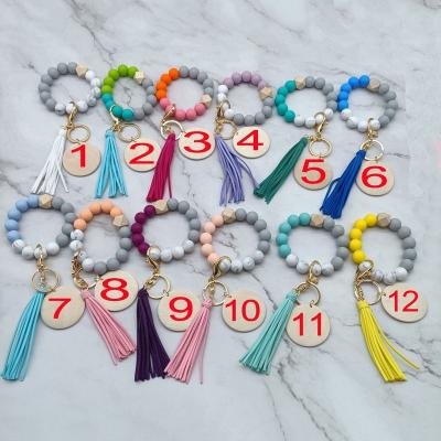 China Fashiontable Monogram Suede Tassel Silicon Beaded Bracelet Key Chain for sale