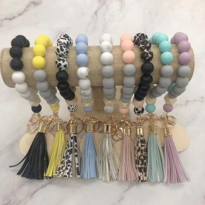 China Fashiontable Wooden Monogram White Disc Silicon Beads Tassel Bracelet Key Chain for sale