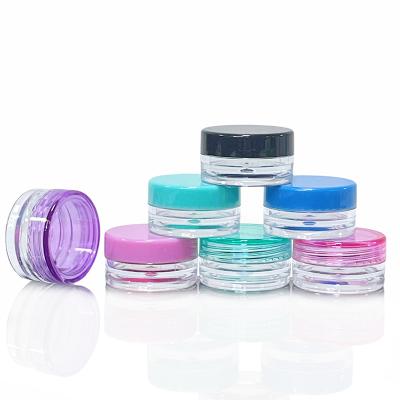 China Small plastic cosmetic jars 5ml beauty cosmetic containers 5 gram lip balm jar with colorful black lids for sale