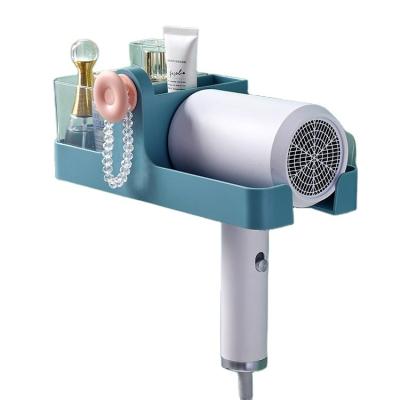 China Hair Dryer Holder Creative Wall Mounted Adhesive Holder Plastic Roll Fashion Storage Hairdryer Holder for sale