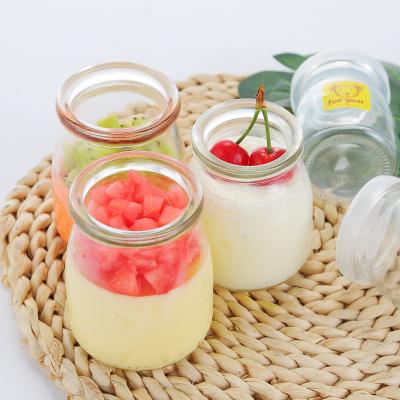 China 100ml 150ml 200ml food glass bottle empty pudding glass jar for milk yogurt with plastic cap for sale