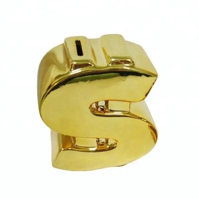 China Cion Bank Variety Funny US Dollar Piggy Bank Gold Shaped Ceramic Coin Bank for sale