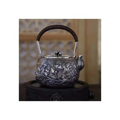 China Viable Chinese Teapot Chinese Handmade Finely Carved Silver Pot With Lotus Embossed Kettle for sale