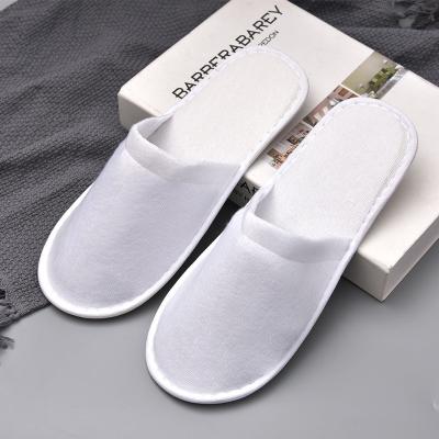 China OEM Logo Personalized Wholesale Cheap White Hotel Room Exquisite Disposable Spa Guest Amenities Disposable Hotel Slipper for sale