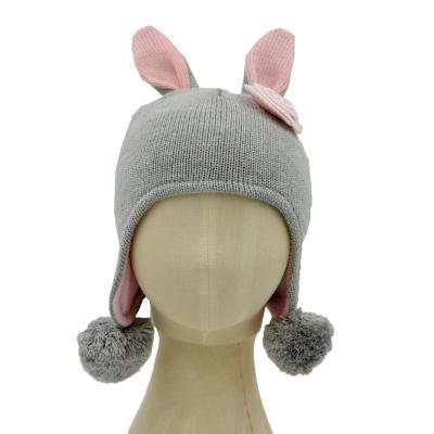 China New Design COMMON Winter Kid Warm Cotton Knitted Animal Earflap Hat With Rabbit Ears And Crocheted Flower for sale