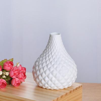 China Textured effect without luster porcelain flower bud modern embossed white vase for home decoration for sale