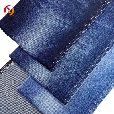 China Breathable wholesale high quality manufacturers prices 380g Blue indigo color twill knitted High stretch cotton raw Denim jeans fabrics for sale