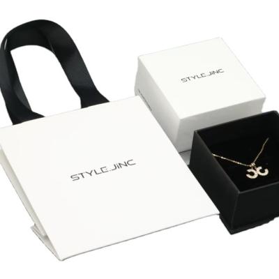 China Handmade White Special Paper Box And Bag Set With Hotstamping Logo Black Gift Packaging for sale