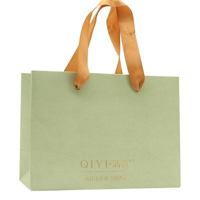 China Disposable Green Special Paper Packaging Bag With Logo Hot Stamping Paper Bag With Handles Yellow Paper Bag for sale