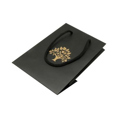 China Disposable Black Paper Bag With Handles With Your Own Logo Gold Paper Hot Stamping Suitcase for sale