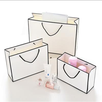 China OEM Apparel Handled Packaging Custom Printed Gift Shopping Logo Oil Proof Tote Cardboard White Paper Kraft Bag With Handle for sale