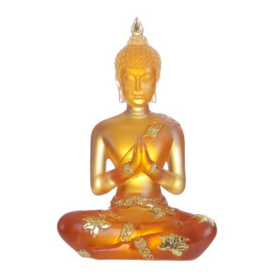 China Wholesale Lucky Small Amber Sitting Buddha Statue Europe Resin Home Decor For Sale Golden Buddha Statue for sale