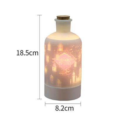 China 2022 Newest Design Glass+PP Rotating Bottle Projector Lights Home Decor Bottle Projector Lights For Ramadan for sale