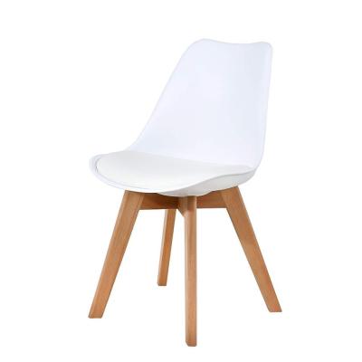 China Langfang Dining Room Modern Elegant Nordic Tulip Chair Design White PU Cooling Plastic Cushion Dining Chair With Wooden Leg for sale