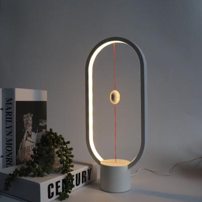 China Modern LED Hanging Magnetic Lamp Desk Lamp Designer Table Lamp Oval LED Night Light Decoration for sale