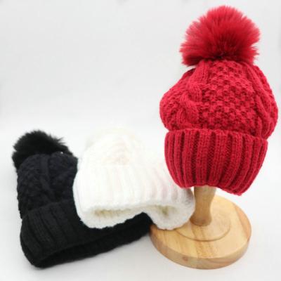 China COMMON New Stylish Custom Thick Blank Chunky Knit Hats Beanie Faux Fur Pompoms Winter Caps for sale