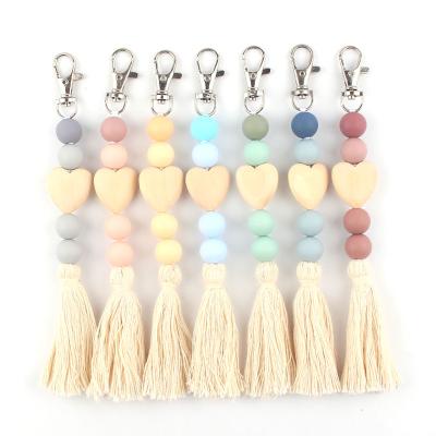 China Free Sample Faux Fur Ball Pompom Chains Customized Silicone Heart Shape Beaded Key Chain DIY Beaded Keychain Car Key Bag Wooden Key Bag Pendant With acorns for sale