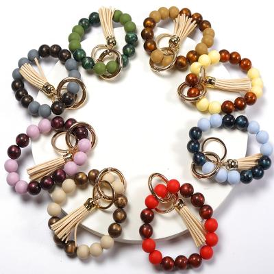 China Faux Fur Ball Pompom Chains Silicone Bracelet Beaded Bracelet Wholesale Key Chain Acrylic Beads Key Chain Purse Bag Pendant With Leather Tassel for sale