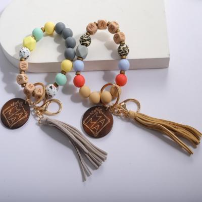 China Faux Fur Ball Pom Pom Chains Custom MOM Monogram Message Wood Bracelet Disc Bead Key Chain Silicone Beaded Tassel Leather Bracelet Key Chain For Mom for sale