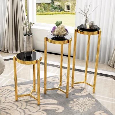 China Modern Round Coffee Table Flower Stand 3 Pieces Stainless Steel Gold Tabletop With Black Glass Complements Simple Design for sale