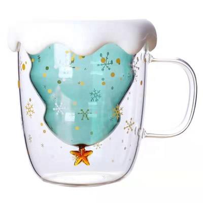 China Green Christmas High Sustainable Solid Borosilicate Double Wall Glass Coffee Mug Heat Resistant Mug With Snow Shape Silicone Lid for sale