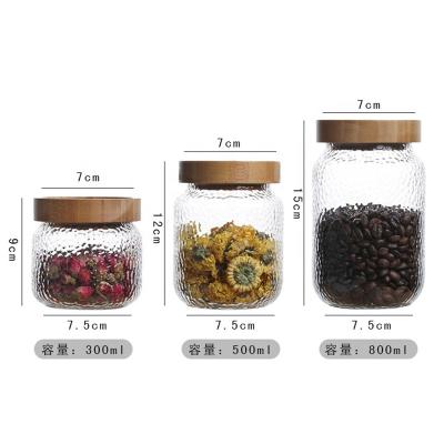 China Sustainable High Borosilicate Pressed Hammerhead Fish Kitchen Food Storage Airtight Glass Bottles And Jars With Wooden Lid for sale