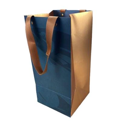 China Handmade Hot selling gift packaging Blue gold hot stamping custom logo ribbon vertical paper bag cosmetics paper bag for sale