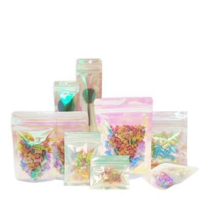 China Pink Moisture Proof Hologram Front Smell Proof Holographic Laser Reusable Clear Small Plastic Zip Lock Food Storage Pouch Packaging Bags for sale