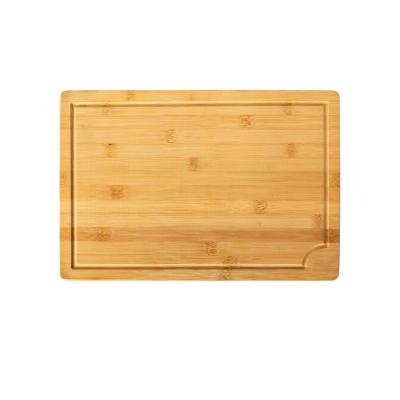 China Large sustainable bamboo wood cutting board with ant-slip mat and juice groove for sale