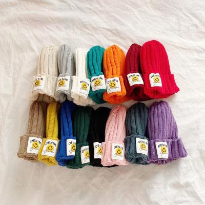 China Autumn and winter color casual children's candy hat cute smile face woolen knitted hat baby fashion striped warm hat for sale