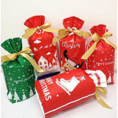 China 50 Pcs Recyclable Christmas Satin Drawstring Favor Treat Bags Plastic Christmas Party Gift Bags Candy Bag Dessert Polybags for sale