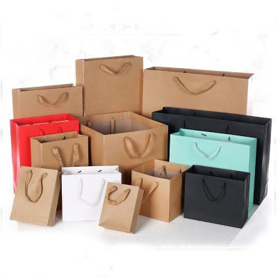 China Custom Recycled Brown Kraft Materials Black White Recycled Boutique Apparel Packaging Handle Luxury Shopping Paper Bag With Your Own Logo for sale