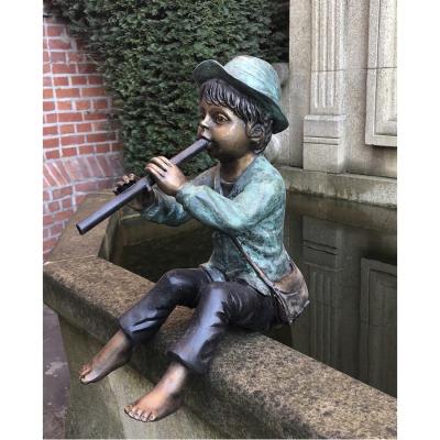 China Europe Street Sitting And Playing Groove Log Child Bronze Statue for sale